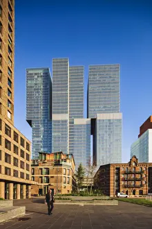 Seaport Prints: A man walking in Noordereiland island in Rotterdam at sunrise with skyscrapers in