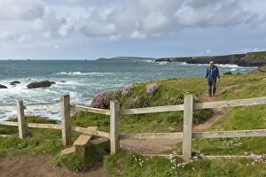 Trevose Head Prints: Man walking the South West Coast Path near Trevose Head, Cornwall, England. Spring