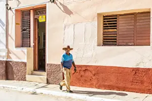 Trinidad Prints: A man walking in a street in Trinidad, Sancti Spiritus, Cuba