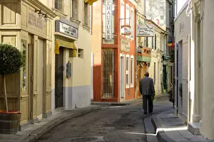 Arles Prints: Man walking in one of the many streets in Arles, Provence Alpes Cote d Azur, France