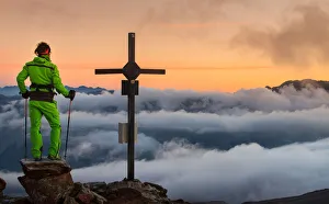Summit Prints: Man watching the sea cloud at sunrise. Valtellina, Lombardy, Italy