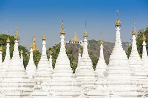 Images Dated 1st March 2016: Mandalay, Myanmar. Kuthodaw pagodas spires with Mandalay hill on the background