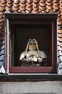 European Union Prints: A mannequin nun stands in the dormwer window of a house in Brugge Sint Kruis