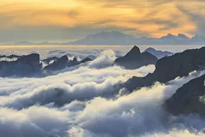 Fogs Collection: Masino valley, low clouds at sunset, in the background Rosa mountain, lombardy, Italy
