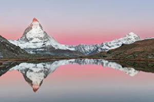 One Man Collection: Matterhorn with reflection in the water of Riffelsee lake, Gornergrat, Zermatt, Valais