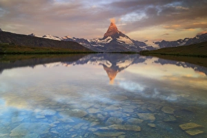 The Matterhorn, Zermatt, Switzerland. The first reflections at sunrise in the waters The Matterhorn, Zermatt, Switzerland. The first reflections at sunrise in the waters