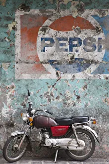 Images Dated 12th February 2009: Mauritius, Port Louis, Chinatown, motorbike in front of Pepsi sign
