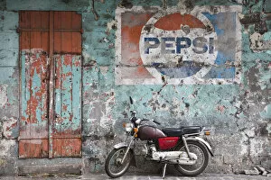 Images Dated 12th February 2009: Mauritius, Port Louis, Chinatown, motorbike in front of Pepsi sign