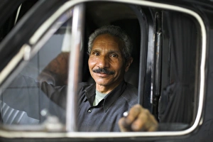 Islamic Gallery: A mechanic sits inside a car at his garage in the district of Zamalek