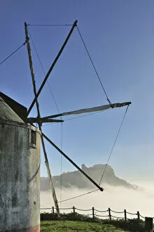 Images Dated 24th May 2013: The medieval castle of Palmela and a windmill in a foggy morning, Portugal