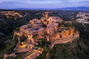 Roof Prints: medieval illuminated village of Civita di Bagnoregio at dusk