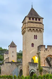 Low Angle Prints: Medieval Pont Valentra bridge over the Lot River at dawn on cloudy morning, Cahors