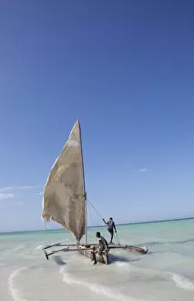 Images Dated 14th January 2011: Two men sailing a boat in the surf off Zanzibar in East Africa