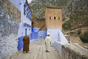 Medina Gallery: Two Men walking on the edge of the medina in Chefchaouen, Morocco