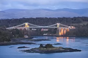 The Menai Bridge spanning the Menai Strait, backed by the mountains of Snowdonia National Park