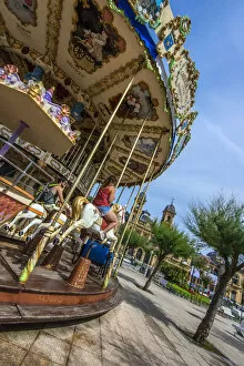 Images Dated 7th August 2014: Merry-go-round with Ayuntamiento or Town Hall behind, Donostia San Sebastian, Gipuzkoa