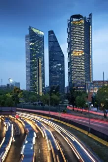 Images Dated 26th February 2016: Mexico, Mexico City, Traffic Passes By Mexico Citys Three Towers, Tallest Skyscrapers In The City