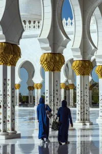 Two Middle Eastern women traditionally dressed walking in the courtyard of the Sheikh Two Middle Eastern women traditionally dressed walking in the courtyard of the Sheikh