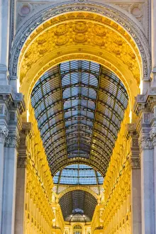 Milan, Lombardy, Italy. The entrance to the Galleria Vittorio Emanuele II illuminated