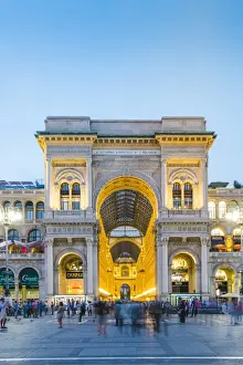 Milan, Lombardy, Italy. The entrance to the Galleria Vittorio Emanuele II illuminated