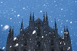 Milans Duomo cathedral in winter with snow and artificial lights. Milan, Lombardy
