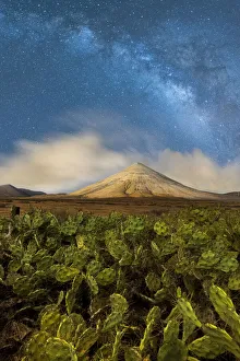Milky Way glowing over Montana del Fronton peak and cactus plants, La Oliva Milky Way glowing over Montana del Fronton peak and cactus plants, La Oliva