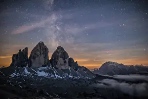 The Milky Way with its stars appear in a summer night on the Three Peaks of Lavaredo