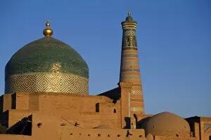 Islamic Architecture Collection: The minaret and tiled dome of a mosque rise above the