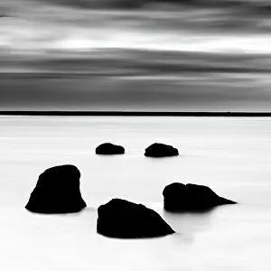 B And W Prints: Minimalist image of 5 rocks in a frozen lagoon in winter, near Vik y Myrdal, South Iceland