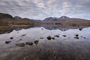 December Prints: Mirror like reflections on Lochan na h-achlaise on Rannoch Moor, Scotland. Winter