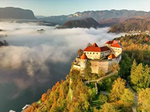 Lake Bled Prints: Mist over Lake Bled below Bled Castle, Bled, Slovenia, Europe