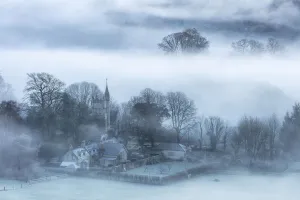 Mist around Melbury Abbas church from Melbury Hill, Cranborne Chase, Dorset, England, UK Mist around Melbury Abbas church from Melbury Hill, Cranborne Chase, Dorset, England, UK