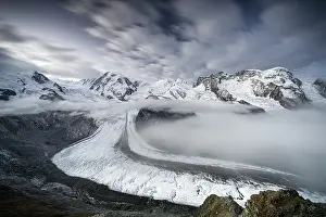 Social Issues Prints: Mist over Monte Rosa glacier and snowy mountains under scenic clouds at dusk