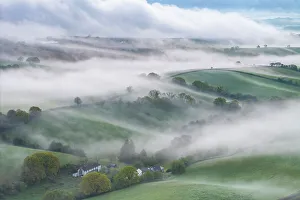 Crediton Prints: Mist shrouded Devonshire countryside at dawn, Crediton, Devon, England. Spring (May) 2024