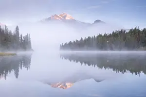 Serene Landscape Prints: A mist shrouded Pyramid Mountain reflected in Pyramid Lake at dawn, Jasper National Park