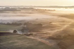 Mid Devon Prints: Mist shrouded rolling countryside at dawn, mid Devon, England. Summer (June) 2023