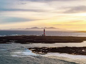Horizon Over Water Prints: Mist at sunrise over El Toston lighthouse and the rippled sea