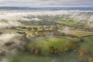 Misty autumn morning above Cadbury Castle Iron Age Hillfort, Cadbury, Devon, England Misty autumn morning above Cadbury Castle Iron Age Hillfort, Cadbury, Devon, England