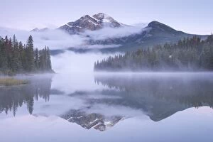 Images Dated 3rd September 2015: A misty Pyramid Mountain reflected in Pyramid Lake at dawn, Jasper National Park