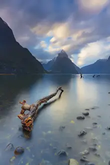 Mitre Peak reflecting in the fjord water at sunset at Milford Sound in New Zealand