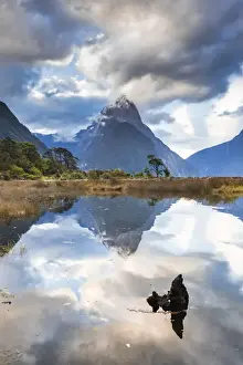Mitre Peak reflecting in the fjord water at sunset at Milford Sound in New Zealand