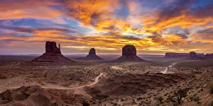 The Mittens against colourful cloudy sky at sunrise, Monument Valley, Arizona, USA
