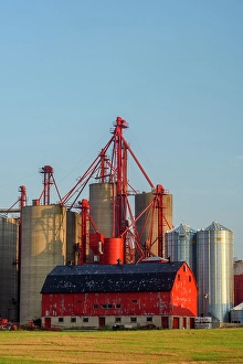 Industrial Prints: A modern grain storage complex together with a traditional red barn