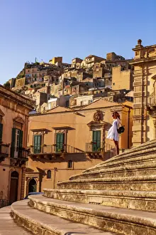 Natural Light Prints: Modica, Sicily. A woman standing on the stairs in front of the baroque Cathedral