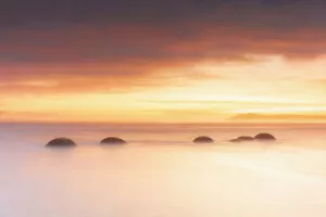 Quiet Gallery: Moeraki Boulders rock formations by the sea at sunrise, Otago, New Zealand