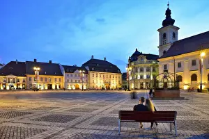 Religious Site Prints: Moment of peace. Piata Mare and the Holy Trinity Roman Catholic Church at dusk. Sibiu