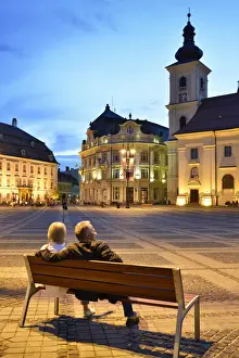Moment of peace. Piata Mare and the Holy Trinity Roman Catholic Church at dusk. Sibiu