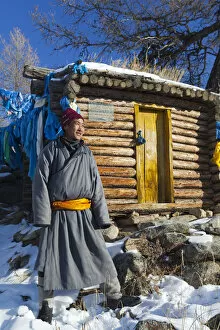 Images Dated 5th March 2012: Mongolia, Ovorkhangai, Orkhon Valley. A Mongolian man stands by a hut at hot springs