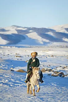 Images Dated 5th March 2012: Mongolia, Ovorkhangai, Orkkhon Valley. A man approaches on horseback at sunrise
