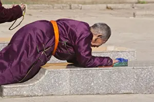 Ulaanbataar Prints: MONGOLIA, Ulaanbaatar, Monk prostrating at Gandan (Gandantegchenling) Monastery
